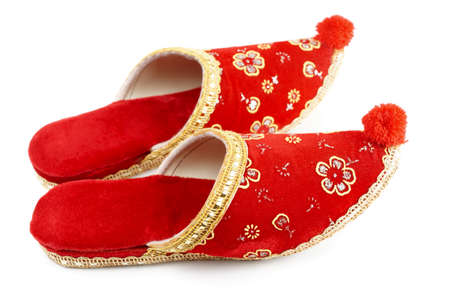 Red embroidered Turkish slippers, decorative footwear isolated on white backgroundの写真素材