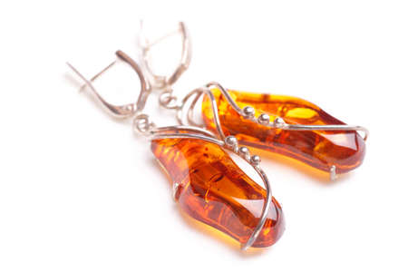 Amber earrings, close-up, isolated on white backgroundの写真素材