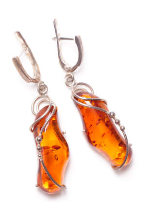 Amber earrings shot from above, isolated on whiteの写真素材