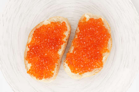 Two loaves of bread with red salmon roe shot from aboveの写真素材