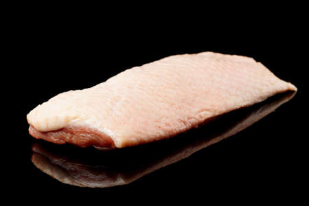 Duck fillet shot on black surface, isolatedの写真素材