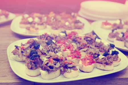 Bruschettas with meat, vegetables and soft cheese, toned image