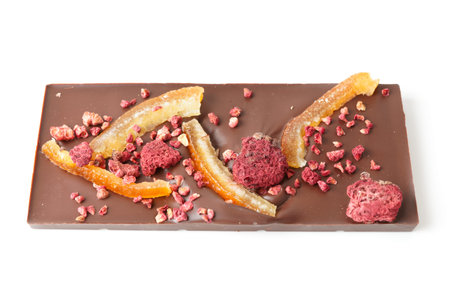 Chocolate bar with candied orange peel and raspberry isolated on white background