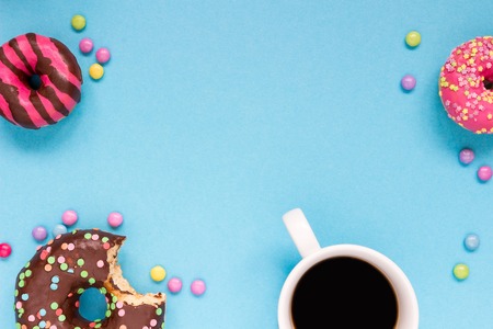 Sweet donuts with coffee on the blue background. Delicious donut.の写真素材