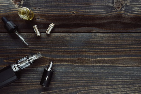 Vaping set with copy space on the wooden background.の写真素材