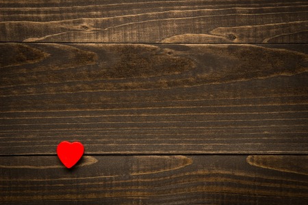 Valentine's Day heart on the wooden dark texture background with copy spaceの写真素材