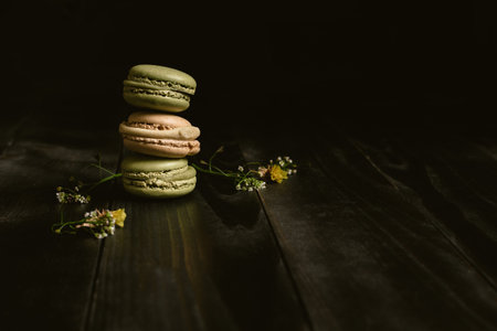 Pistachio delicious macaroons on the wooden table, with copy space.の写真素材