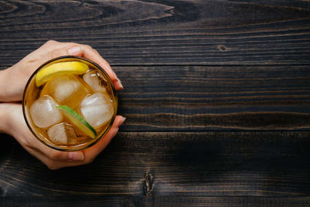 Fresh ice drink with lemon and lime on the wooden table, top view. With copy space.の写真素材