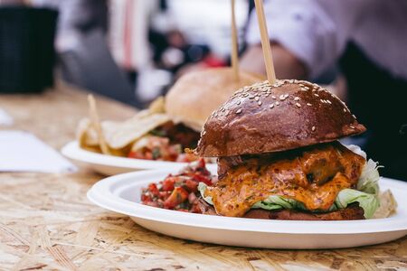 Fresh tasty grilled meat burger with sauce and cheddar on the table. Selective focus.の写真素材