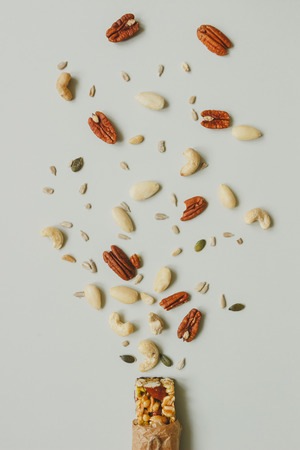 Healthy bar with nuts and seeds on the gray background, top view.の写真素材