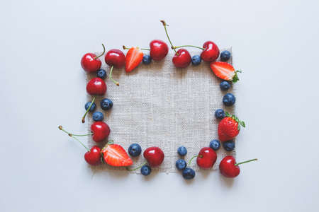 Summer background. Fresh juicy berries on the blue background, top view.の写真素材