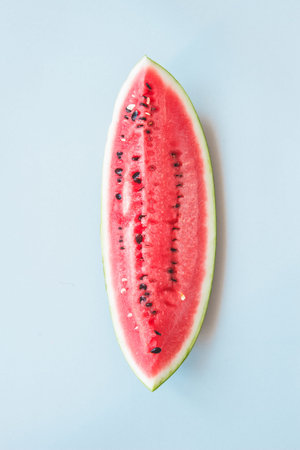 Fresh ripe watermelon on the blue background, top view. Summer time concept.