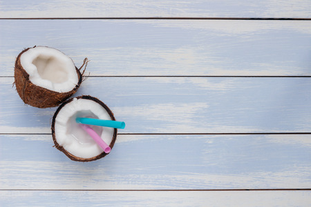 Ripe coconut on the wooden blue table, top view, with copy space.の写真素材