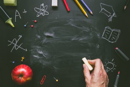 Back to school. School supplies on the blackboard background with copy space.の写真素材