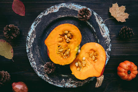 Ripe pumpkin on the wooden background, top view.の写真素材