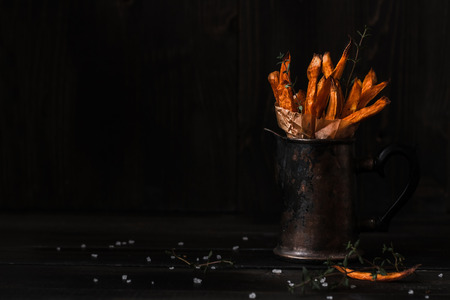 Delicious homemade sweet potato french fries on the wooden table. Copy spaceの写真素材