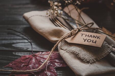 Thanksgiving decoration with cutlery and napkin on the wooden table, close up. Selective focus.の写真素材