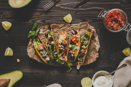 Mexican tacos with salsa and avocado on the wooden background, top view.の写真素材