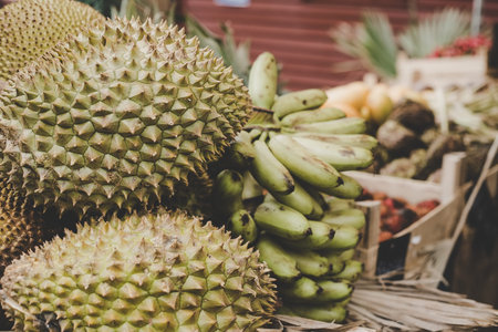 Exotic tropical fruits. Durian, jackfruit and bananas at street food market.