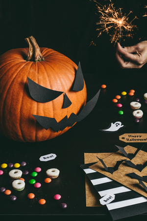 Halloween preparation. Hands making halloween cards using craft paper.の写真素材