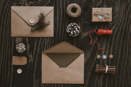Christmas package. Christmas cards, gifts and christmas decoration on wooden table, top view.の写真素材