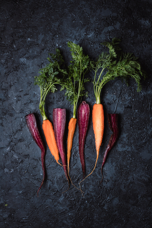 Fresh harvested organic carrots on black background top viewの写真素材