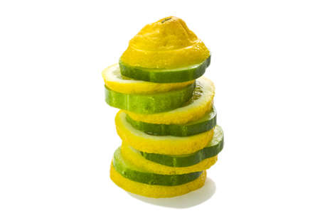Lemon and cucumber, cut into slices, isolated on white backgroundの写真素材