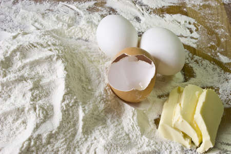 Eggs, butter and flour on the tableの写真素材