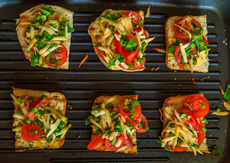 bread grilled with cheese, onions and tomatoes