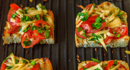 bread grilled with cheese, onions and tomatoes