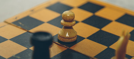 Vintage wooden chess on the chess board closeup