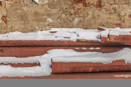 old rusty metallic background on the street in winterの写真素材