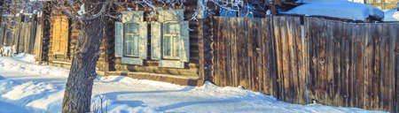 The windows of the old wooden house in the winterの写真素材