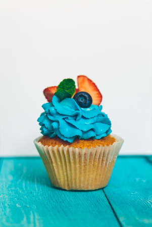 cupcakes on a blue vintage wooden backgroundの写真素材