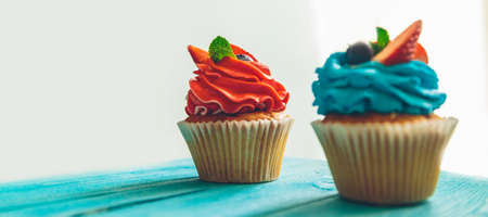 cupcakes on a blue vintage wooden backgroundの写真素材