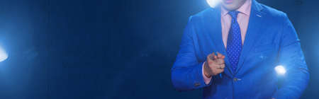 man with pen in hand on a dark backgroundの写真素材