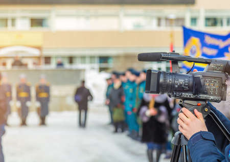 Cameraman shooting a military parade in the winterの写真素材