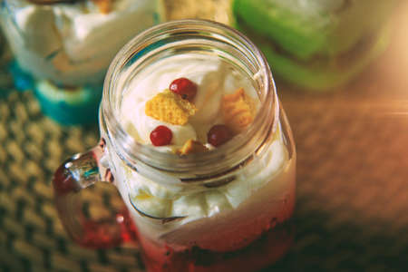Dessert with whipped cream, biscuits and cranberriesの写真素材