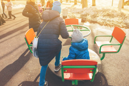 children play in a playground in the springの写真素材