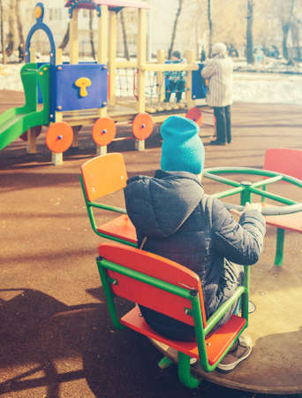 children play in a playground in the springの写真素材