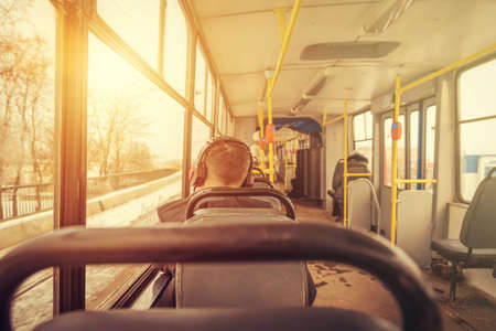 young man in headphones in a tram close upの写真素材
