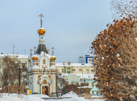 Old chapel in the middle of a winter city in Russia