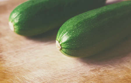 close view green zucchini on wooden surfaceの写真素材
