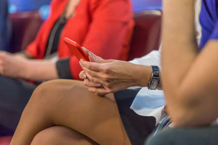 A woman is typing a message on the smartphone close upの写真素材