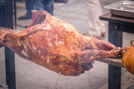 Preparing a ram on a spit on the streetの写真素材
