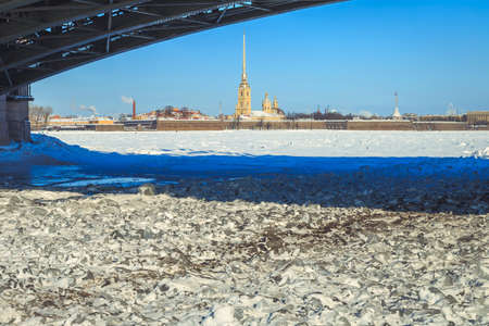 a view of the Peter and Paul Fortress from under the Palace Bridge in St. Petersburg in the winterの写真素材