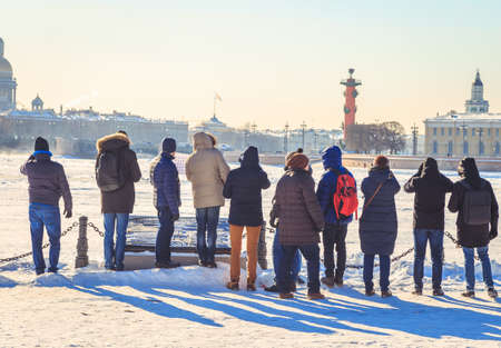tourists on the Neva embankment in St. Petersburg on a sunny frosty day in the winterの写真素材