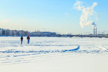 Smoke from the pipes of the factory in winterの写真素材