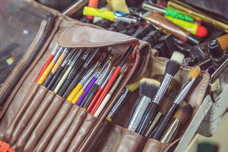 cosmetics and makeup brushes in the dressing room near the mirror close-upの写真素材