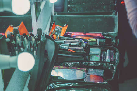 cosmetics and makeup brushes in the dressing room near the mirror close-upの写真素材